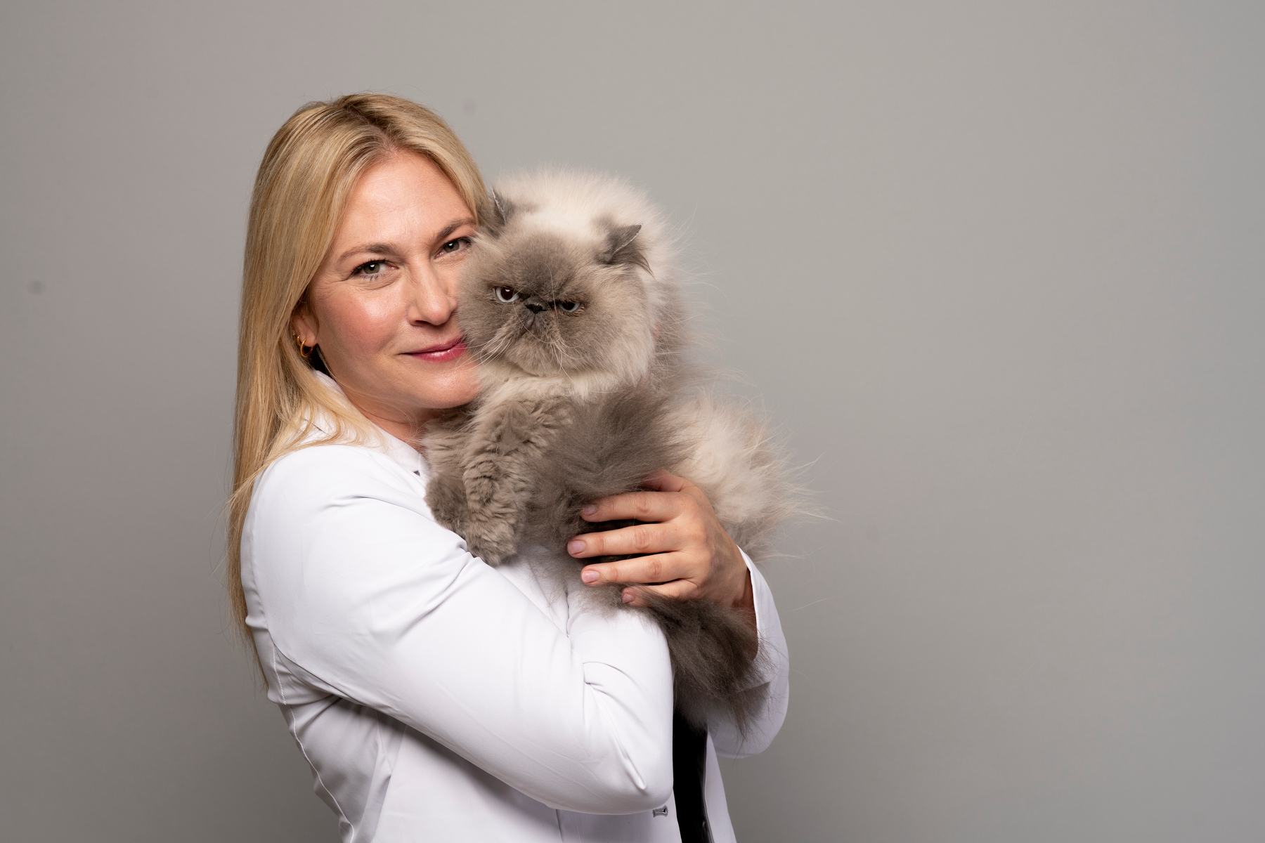 Dr. Caren hugging a fluffy Persian cat