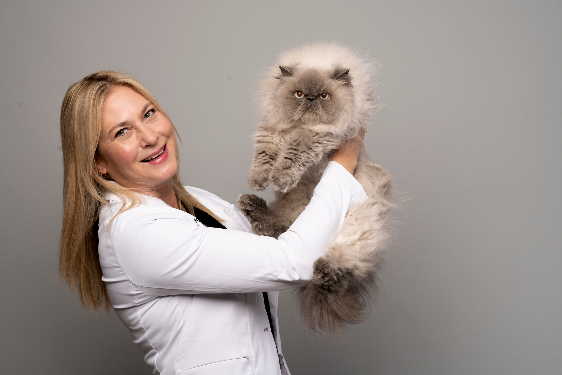 Dr. Caren holding a Persian cat
