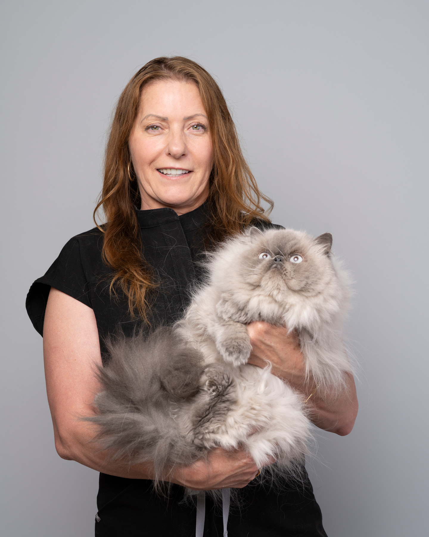 Sandy holding a fluffy Persian cat